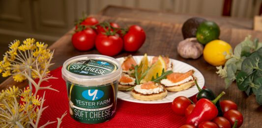 Yester Farm scoops up 3-star Great Taste Award A tub of Yester Farm Dairies Soft Cheese sits next to a plate with canapés on it and different foods around the plate.