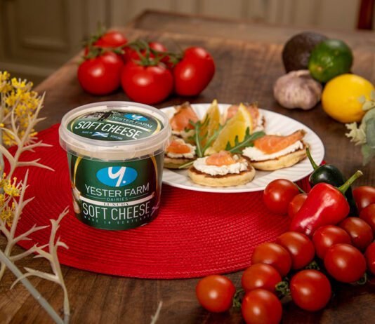 Yester Farm scoops up 3 star Great Taste Award A tub of Yester Farm Dairies Soft Cheese sits next to a plate with canapés on it and different foods around the plate.