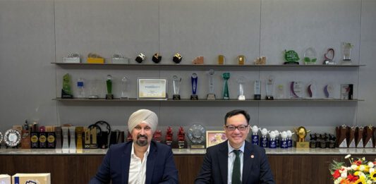 Asco Foods gains distribution for Vitasoy Representatives from Asco Foods and Vitasoy sit at a table signing a new distribution deal between the two firms.