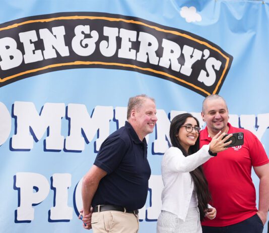 Chris Cobb wins UK-wide Ben & Jerry’s competition Chris Cobb, store owner of Cults Stores – KeyStore, stands with Ghayda Jameel, senior account exec at Cirkle, and Andrew Young, business development exec at The Magnum Ice Cream Company, stand together to take a selfie in front of the Ben & Jerry's Community Picnic banner.
