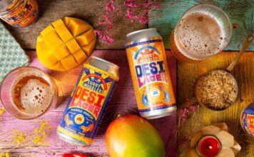 Curry Smugglers launches new Desi Beer brand Cans of Desi Lager Basmati Rice Lager and alcohol-free Mango Mirchi Lager lay on a table with food ingredients around it and glasses with the beers poured into them.