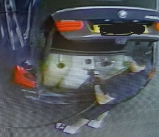 Forecourt Eye offers enhanced tech to combat fuel theft A man fills up plastic containers in the boot of his car with fuel.