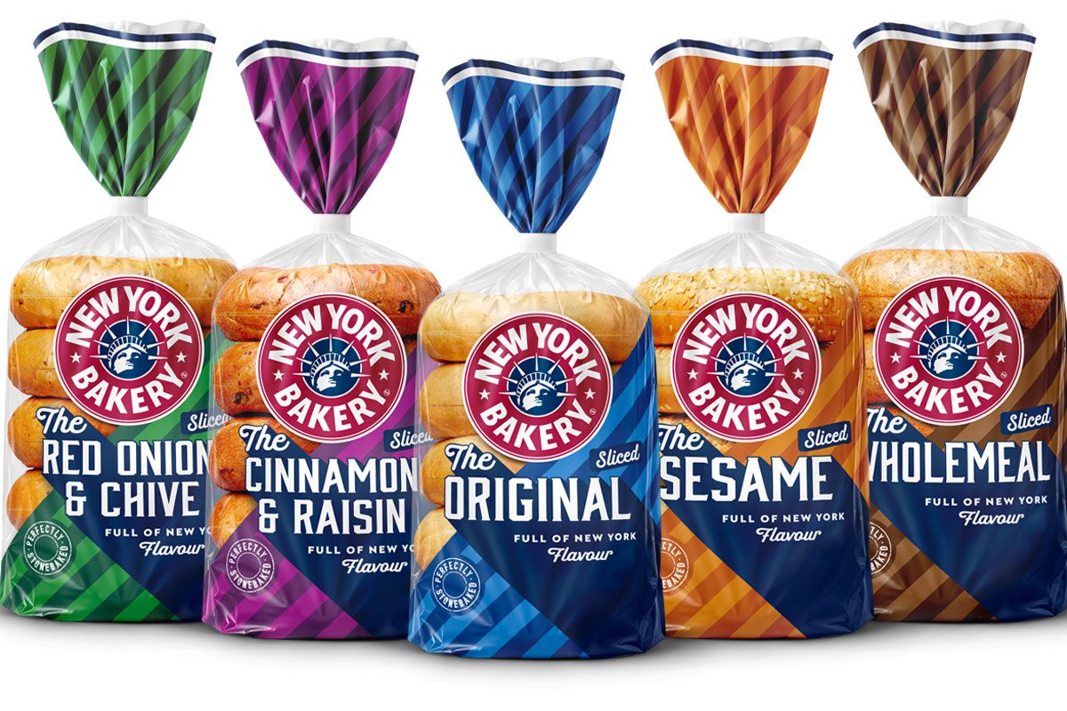 Pack shots of New York Bakery pre-sliced bagels range including Red Onion & Chive, Cinnamon & Raisin, Original, Sesame and Wholemeal.