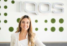 Philip Morris hires new director of smoke-free products Bahar Demirci, senior director of smoke-free products at Philip Morris Limited, stands in front of the IQOS logo.