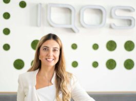 Philip Morris hires new director of smoke-free products Bahar Demirci, senior director of smoke-free products at Philip Morris Limited, stands in front of the IQOS logo.
