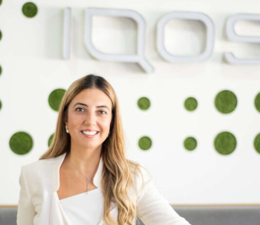 Philip Morris hires new director of smoke-free products Bahar Demirci, senior director of smoke-free products at Philip Morris Limited, stands in front of the IQOS logo.