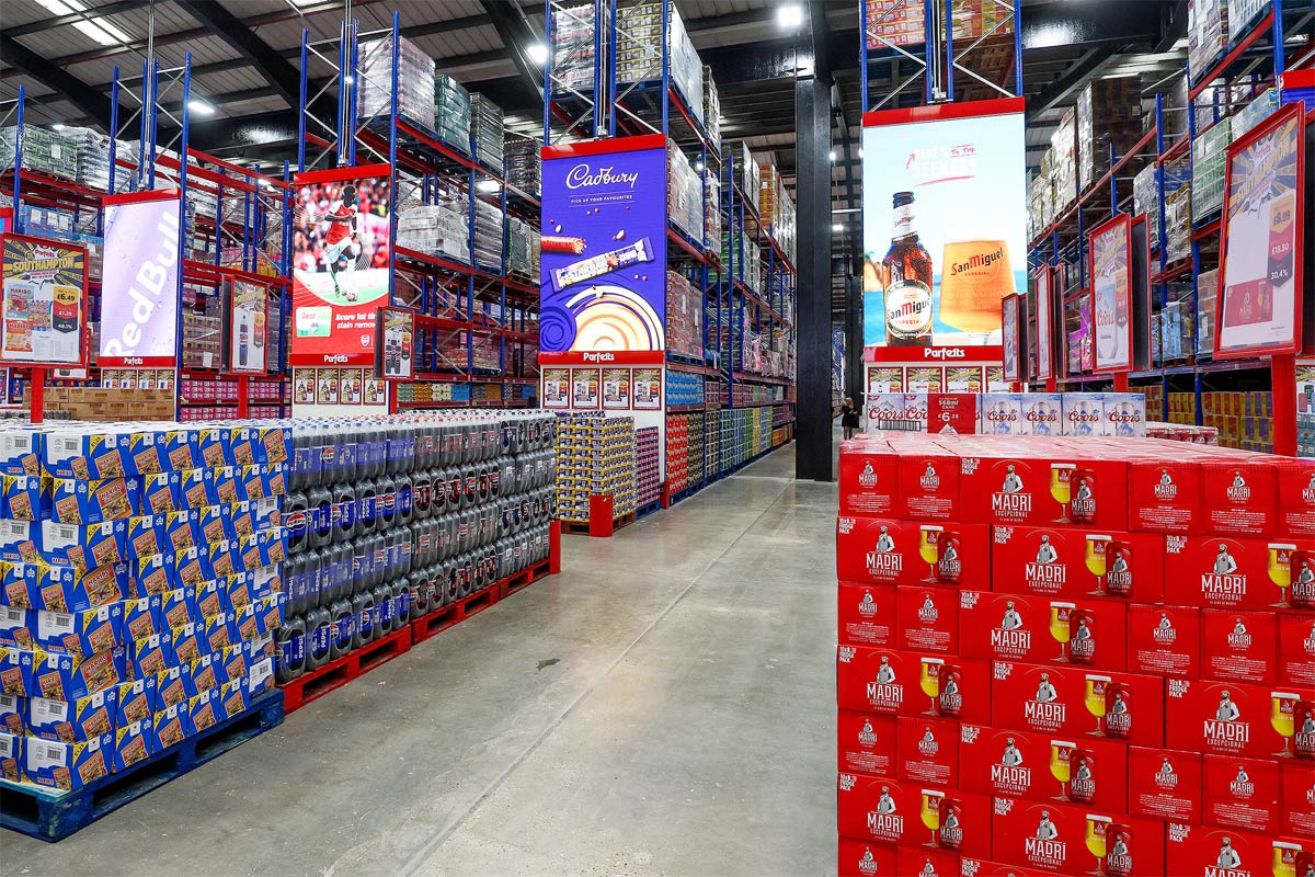 Interior image of a Parfetts depot with stacks of products lined up across its aisles.
