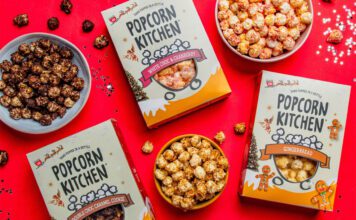 Popcorn Kitchen unveils Christmas gifting range Packs of Popcorn Kitchen Christmas gift packs lie across a red tabletop with bowls of the popcorn around them. The flavorus include White Choc & Raspberry, Double Choc Caramel Cookie and Gingerbread.