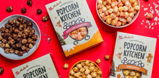 Popcorn Kitchen unveils Christmas gifting range Packs of Popcorn Kitchen Christmas gift packs lie across a red tabletop with bowls of the popcorn around them. The flavorus include White Choc & Raspberry, Double Choc Caramel Cookie and Gingerbread.