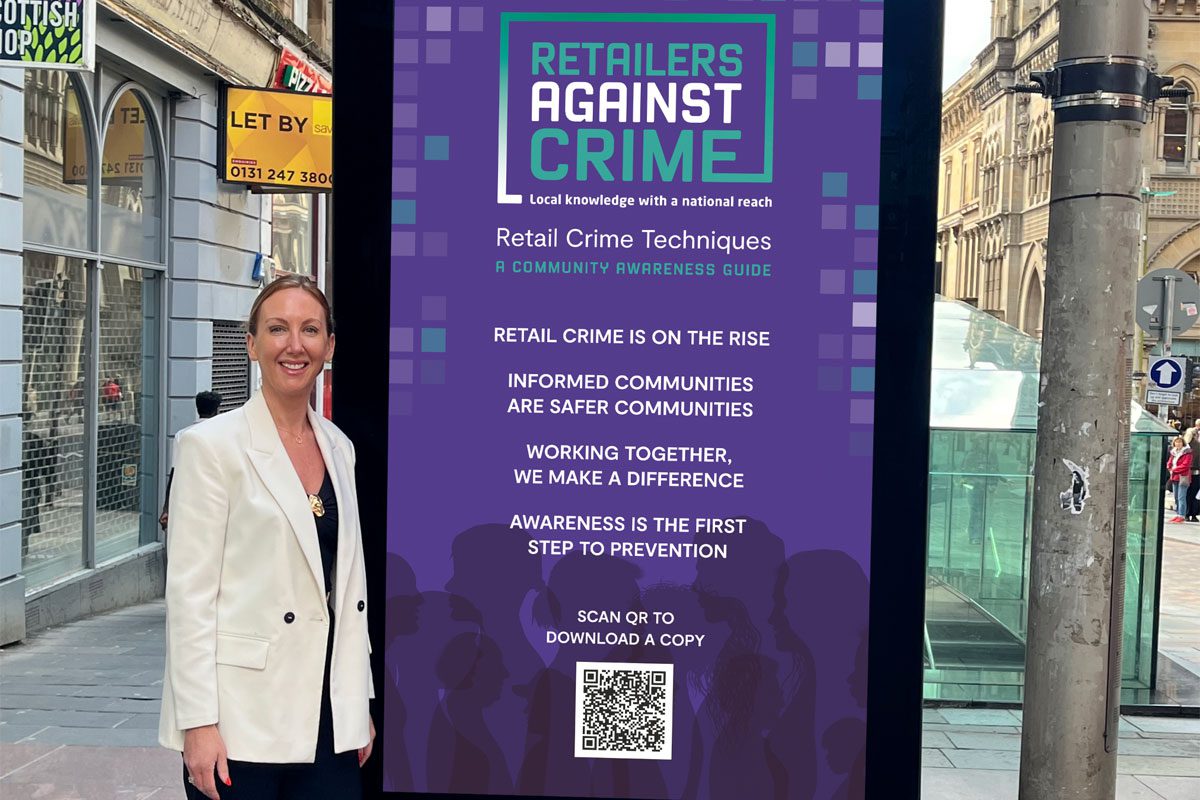 Stephanie Karte, chief executive at Retailers Against Crime, stands next to an electronic billboard in Glasgow's Buchanan Street which features the Retailers Against Crime marketing campaign.