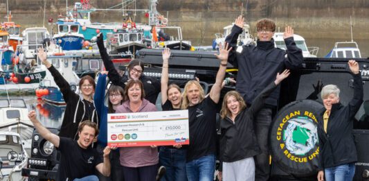 Spar Scotland donates £13k to local causes Paula Middleton, head of marketing at CJ Lang & Son, stands with the Cetacean Research & Rescue Unit holding a cheque for £10,000.