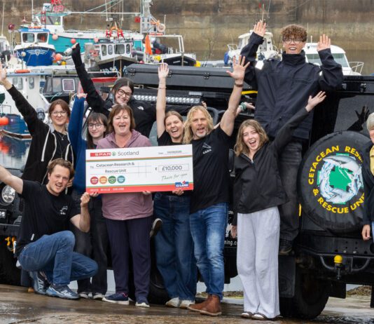 Spar Scotland donates £13k to local causes Paula Middleton, head of marketing at CJ Lang & Son, stands with the Cetacean Research & Rescue Unit holding a cheque for £10,000.
