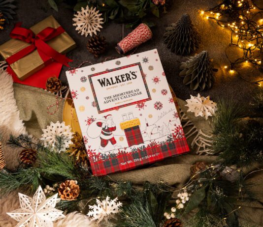 Walker’s Shortbread Advent Calendar returns for 2026 A Walker's Shortbread Advent Calendar sits in the middle of a Christmas scene with presents, decorations and lights.