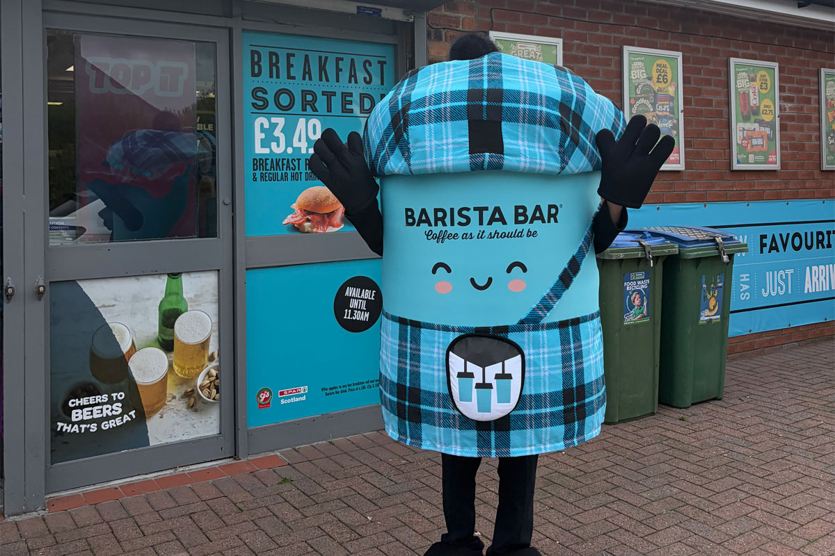 Spar Scotland's Barista Bar mascot 'Robert the Brews' stands outside a Spar store in Dumfries.