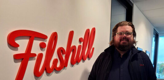 Filshill develops talent with new promotions Scott Sutherland, regional development manager at JW Filshill, stands next to the Filshill logo at the company's offices.