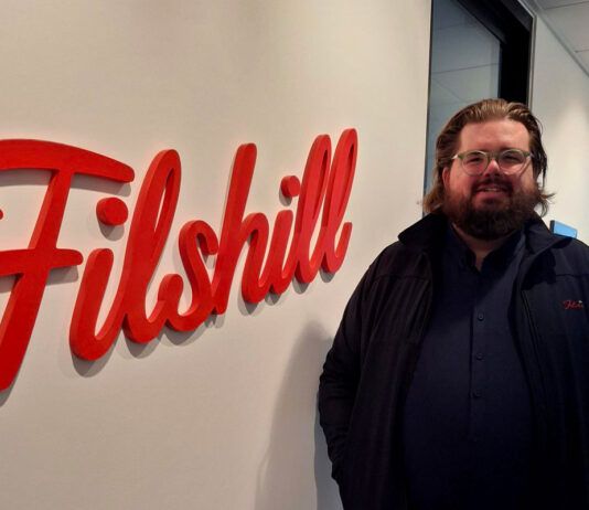 Filshill develops talent with new promotions Scott Sutherland, regional development manager at JW Filshill, stands next to the Filshill logo at the company's offices.