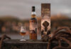 Glen Scotia unveils latest Campbeltown series whisky A bottle of Glen Scotia Icons of Campbeltown No.4 stands on a barrel on a dock with the outer case next to it and a nosing glass on its other side with the whisky inside.