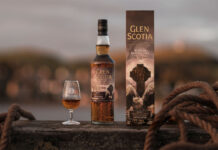 Glen Scotia unveils latest Campbeltown series whisky A bottle of Glen Scotia Icons of Campbeltown No.4 stands on a barrel on a dock with the outer case next to it and a nosing glass on its other side with the whisky inside.