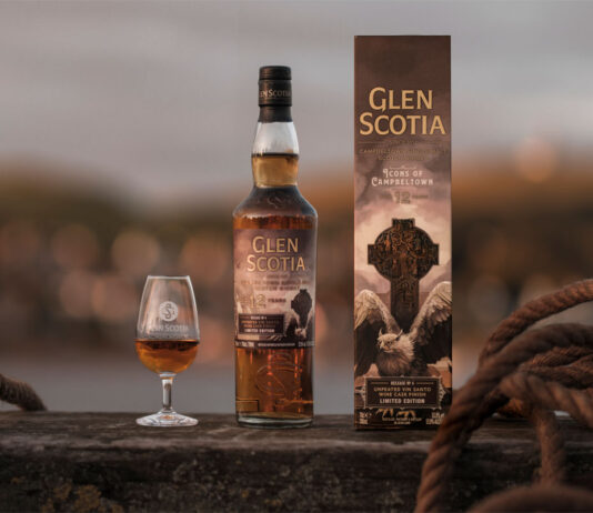 Glen Scotia unveils latest Campbeltown series whisky A bottle of Glen Scotia Icons of Campbeltown No.4 stands on a barrel on a dock with the outer case next to it and a nosing glass on its other side with the whisky inside.