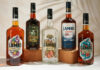 LMB UK secures Lamb’s Rum range Bottles of Lamb's Rum variants sit against a white background with palm leaf shadows over them.