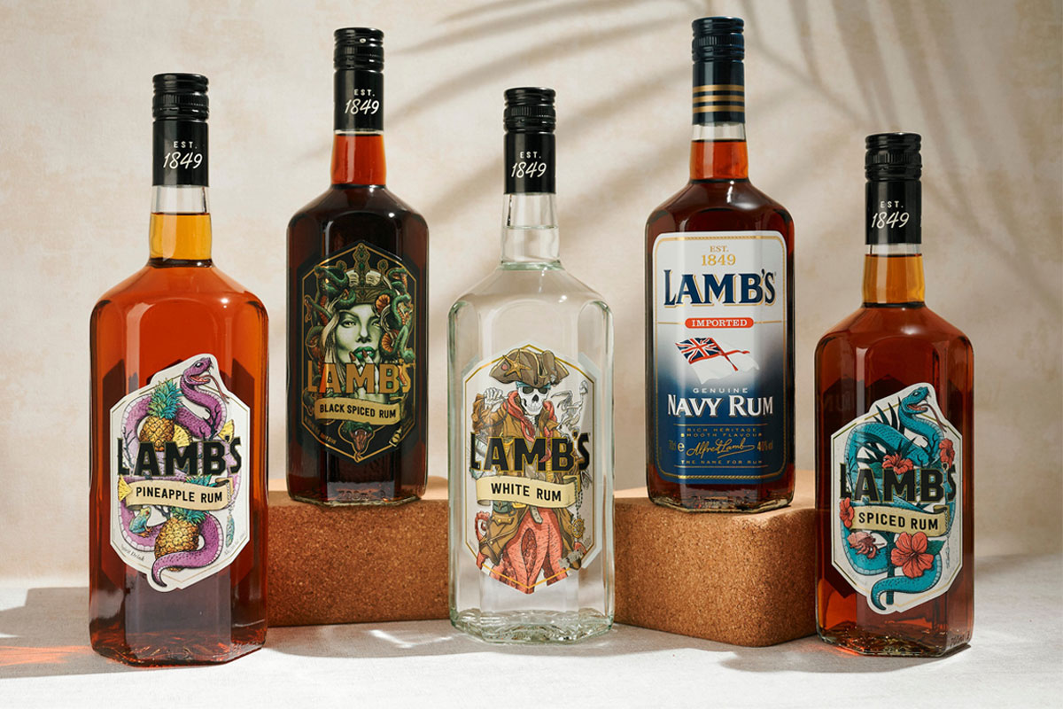 Bottles of Lamb's Rum variants sit against a white background with palm leaf shadows over them.