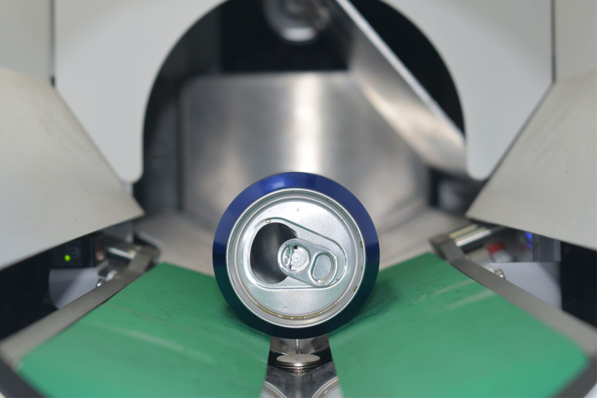 A can is being processed inside a reverse vending machine.