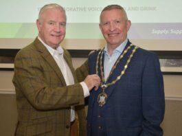 New president for Scottish Wholesale Association Outgoing president Tom Slaven hands over the chain of office to new president Jon Mack.