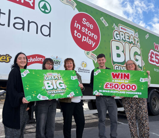 Spar Scotland kicks off Great Big Giveaway promo Members of the Spar Scotland team hold banners for the Great Big Giveaway promotion while standing in front of a Spar Scotland delivery truck with the campaign's livery across it.