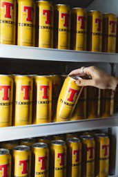 Tennent's cans and hand