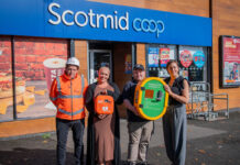 Taylor Wimpey donates defibrillator to Scotmid A group of people stand outside Scotmid Ratho Station holding a defibrillator device that is to be installed on the store's exterior wall.