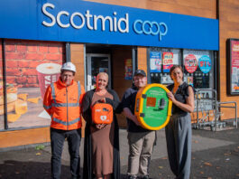 Taylor Wimpey donates defibrillator to Scotmid A group of people stand outside Scotmid Ratho Station holding a defibrillator device that is to be installed on the store's exterior wall.