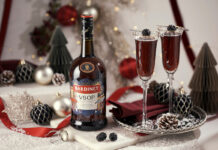 Bardinet rolls out limited edition design for Christmas A bottle of Bardinet VSOP stands on a table with two cocktail serves next to it. There is a range of Christmas decorations across the table as well.