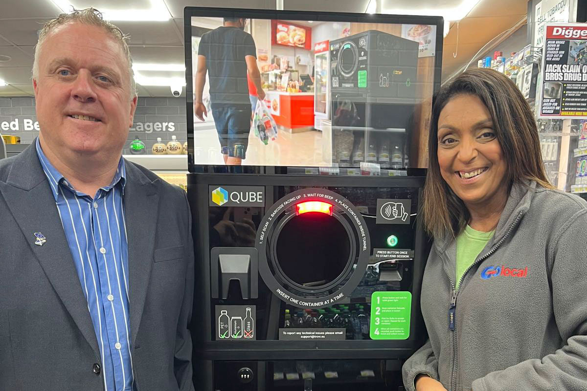 Bob Doris SNP MSP stands in Go Local Partick with owner Nathalie Fullerton next to the TROVR QUBE RVM.