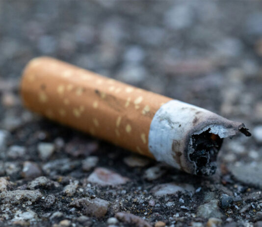 Over 100,000 illegal cigarettes seized in Dumfries A discarded cigarette butt is on the ground.