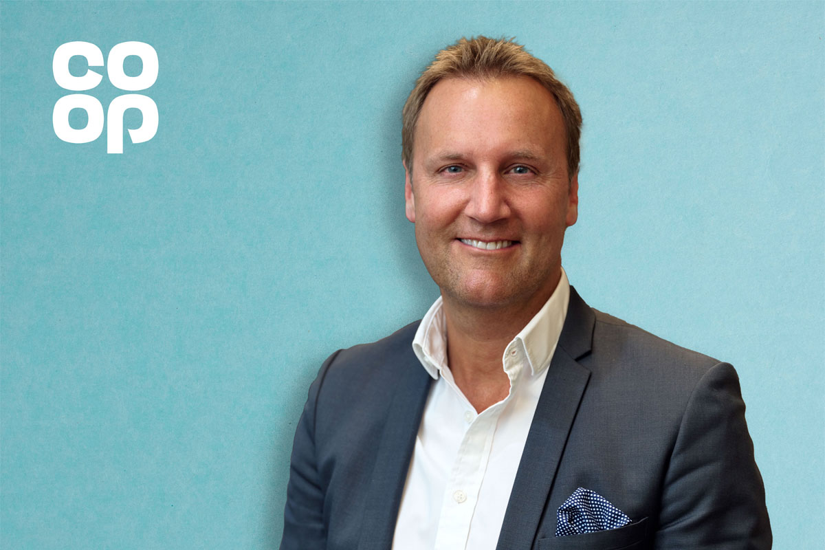 Head shot of Alex Dower, managing director of Co-op Retail. The Co-op logo is in the top left hand corner against a blue background.