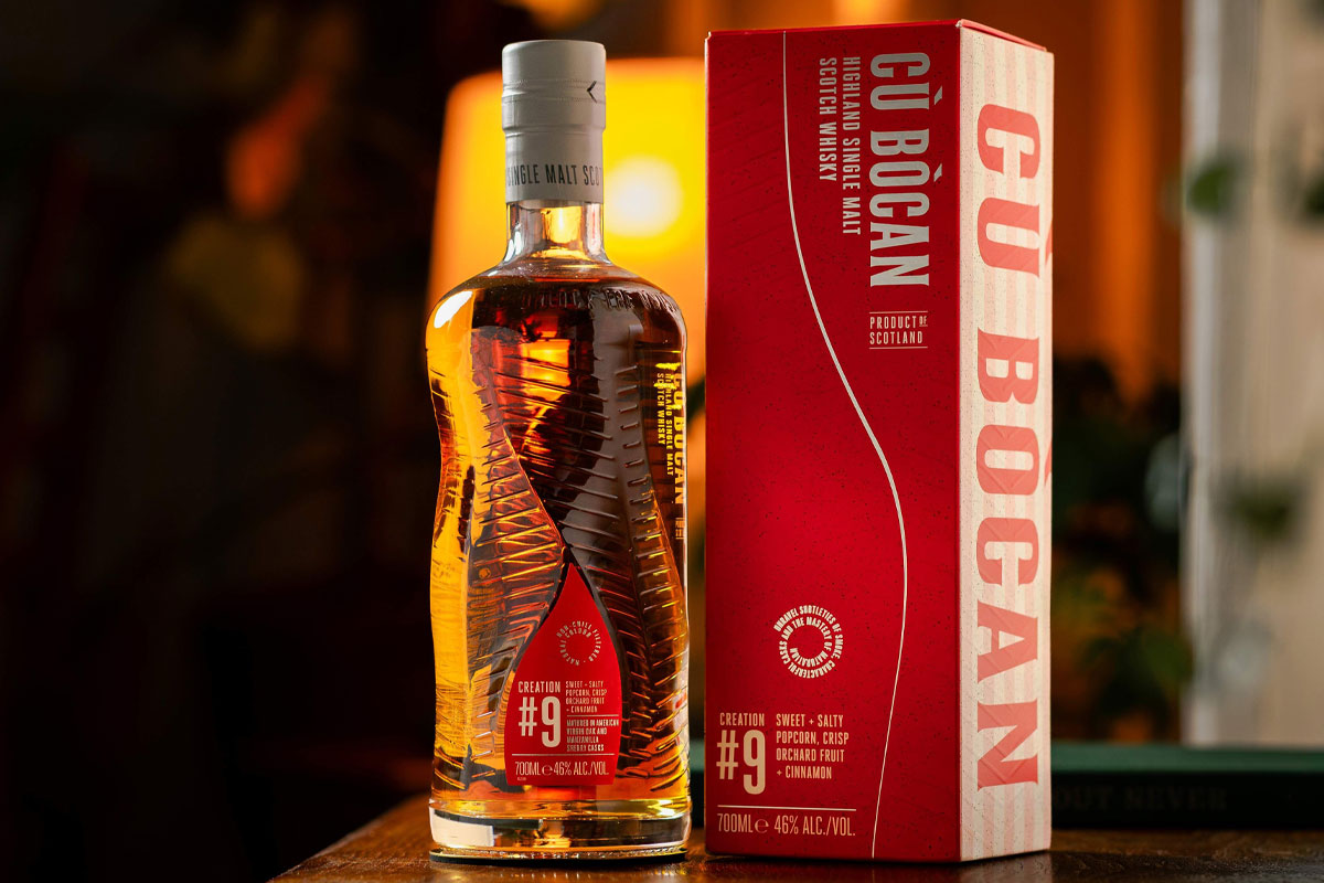 A bottle of Cù Bòcan Creation #9 stands on a table with its outer packaging next to it.