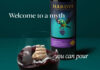 Hardys wine unveils complete brand refresh Promotional image of the new Hardys wine redesign with a bottle of the wine in the background with a glass of red wine poured in front of it. The wine inside mimics a stormy sea with a ship in the tides. The text around the two reads 'Welcome to a myth you can pour'.
