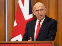 Budget aims to offer ‘breathing space’ for businesses John Healey, Chancellor of the Exchequer, stands at a podium delivering a speech with the UK flag behind him.