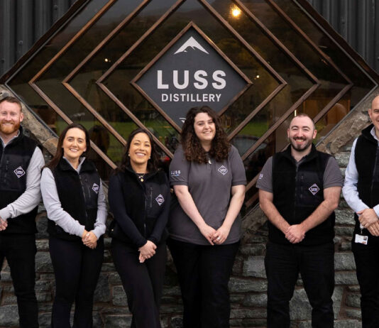 Luss Distillery marks first anniversary Team members from the Luss Distillery stand outside the building with the Luss Distillery logo behind them.