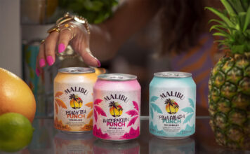 Malibu doubles down on RTDs with new Malibu Punch range Cans of Malibu Punch sit on a bar as a person's hand reaches for them. There is also different pieces of fruit across the bar.