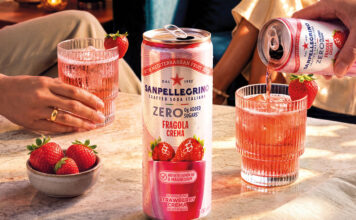 Sanpellegrino adds new Strawberry Crema to Zero range A can of Sanpellegrino Zero Strawberry Crema stands on a table with glasses with the drink inside them behind it and a bowl of strawberries next to it.