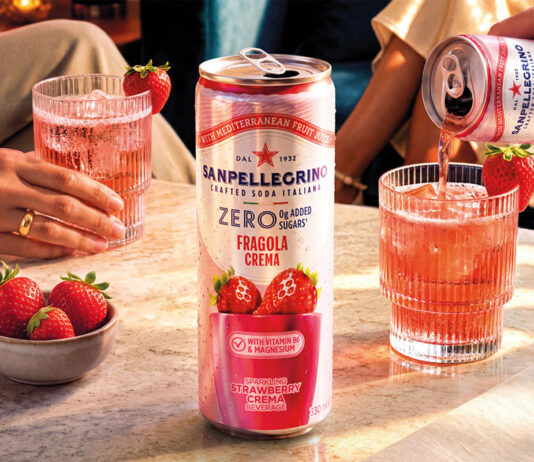 Sanpellegrino adds new Strawberry Crema to Zero range A can of Sanpellegrino Zero Strawberry Crema stands on a table with glasses with the drink inside them behind it and a bowl of strawberries next to it.