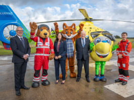 Scotmid partnership with Air Ambulance takes off Scotmid Co-op representatives and members of Scotland's Charity Air Ambulance stand on a heliport with their respective mascots and a helicopter behind them.