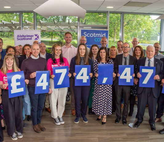 Scotmid marks landmark fundraising for Alzheimer charities Members of the Scotmid Co-op and Alzheimer Scotland teams stand together holding signs that read £474,474 to highlight the fundraising the retail chain has made for the charity.