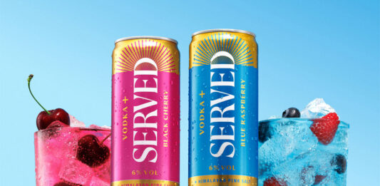 Served rolls out Vodka+ range across Booker Cans of Served Vodka+ stand on a blue table against a blue background with the drinks poured out into glasses next to them with pieces of fruit inside.