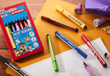 Stabilo rolls out Paw Patrol collection A pack of Stabilo Paw Patrol Trio Scribbi pens sits on a desk with the pans scattered across it with other stationary and pieces of paper.