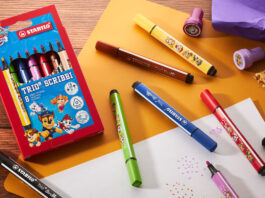 Stabilo rolls out Paw Patrol collection A pack of Stabilo Paw Patrol Trio Scribbi pens sits on a desk with the pans scattered across it with other stationary and pieces of paper.