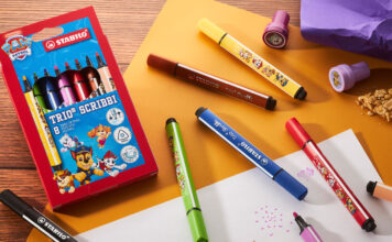 Stabilo rolls out Paw Patrol collection A pack of Stabilo Paw Patrol Trio Scribbi pens sits on a desk with the pans scattered across it with other stationary and pieces of paper.