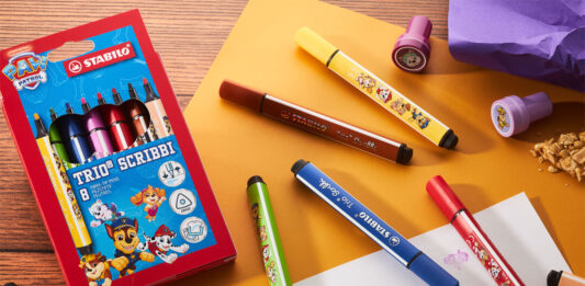 Stabilo rolls out Paw Patrol collection A pack of Stabilo Paw Patrol Trio Scribbi pens sits on a desk with the pans scattered across it with other stationary and pieces of paper.