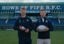 The Famous Grouse backs grassroots rugby with competition Members of the Howe of Fife RFC team stand on a rugby pitch holding a rugby ball as well as a bottle of The Famous Grouse.